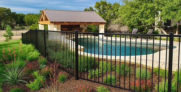 Iron fence surrounds community pool.